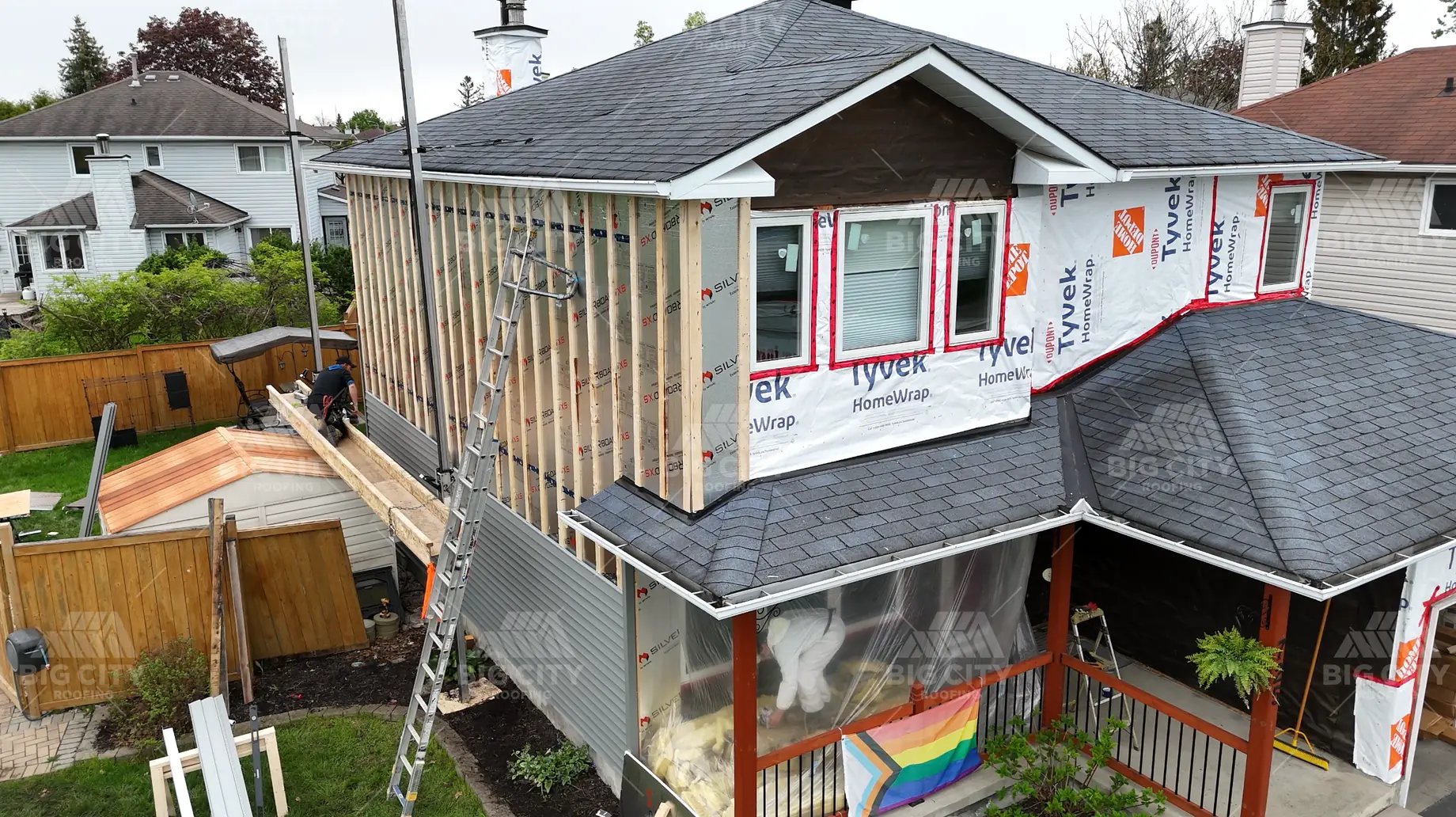 Exterior wall with house wrap being covered with new siding